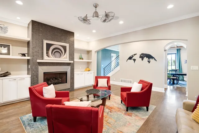 a living room with furniture fireplace and wooden floor