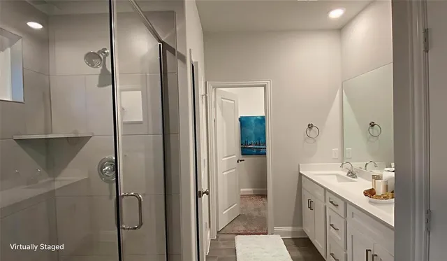 a bathroom with a double vanity sink a mirror and a shower