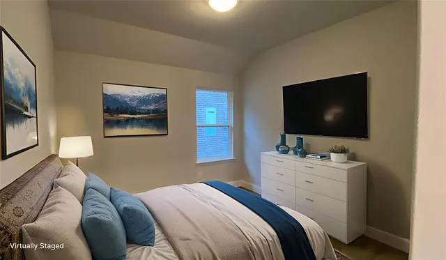 a bedroom with a bed and a flat screen tv