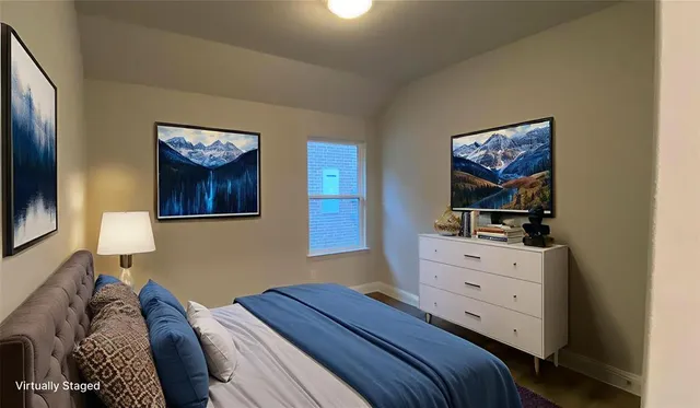 a bedroom with a bed and a dresser
