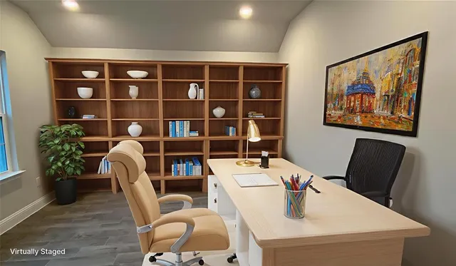 a work room with furniture and a bookshelf