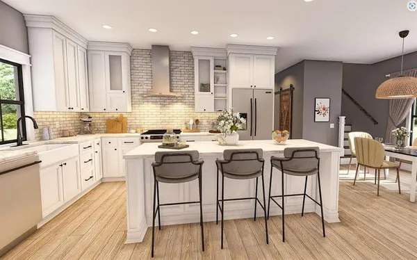 a kitchen with stainless steel appliances kitchen island granite countertop a stove a sink a dining table and chairs