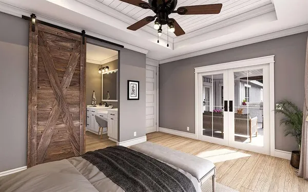a bedroom with a bed and a mirror