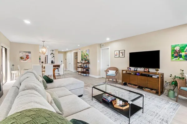 a living room with furniture and large windows