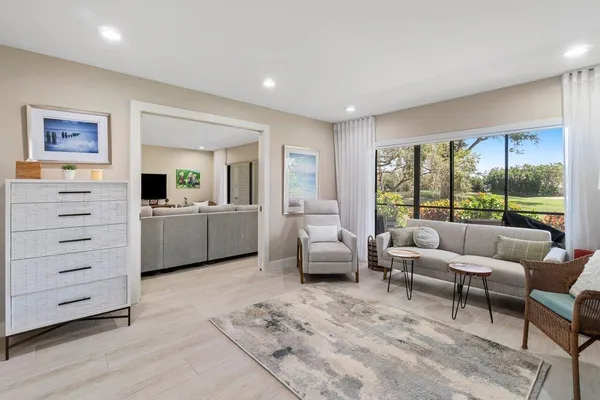 a living room with furniture and large window