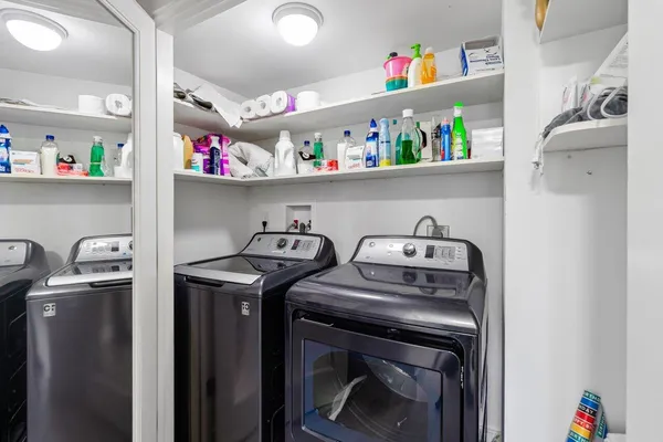 a bedroom with a bed and a dresser next to a window