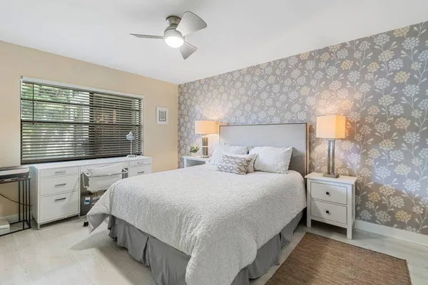 a living room with furniture and a floor to ceiling window
