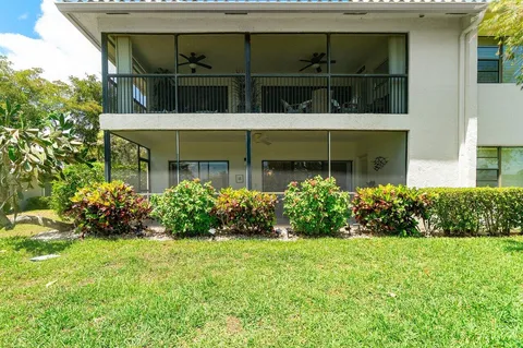 a view of yard with swimming pool and green space