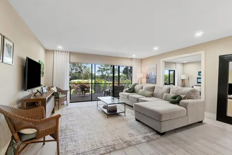 a kitchen with stainless steel appliances kitchen island granite countertop a refrigerator and a stove top oven