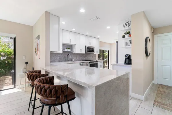 a view of a dining room with furniture and a floor to ceiling window