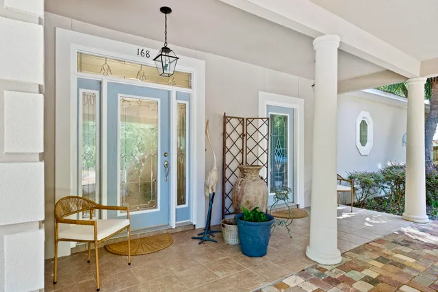 a dining room with a glass top table and chairs
