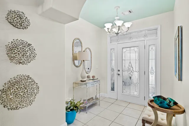 a dining room with wooden floor a chandelier a sink and a chandelier