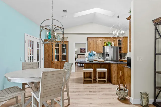 a view of a dining room with furniture wooden floor and chandelier
