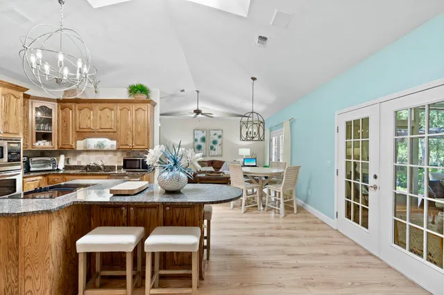 a view of a dining room with furniture a rug and wooden floor
