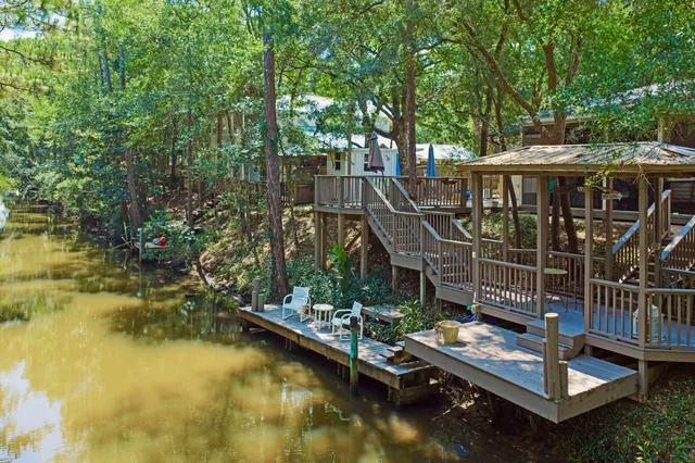 a view of house with swimming pool and outdoor seating