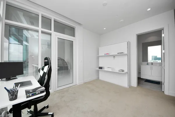 a spacious bedroom with a bed and a desk