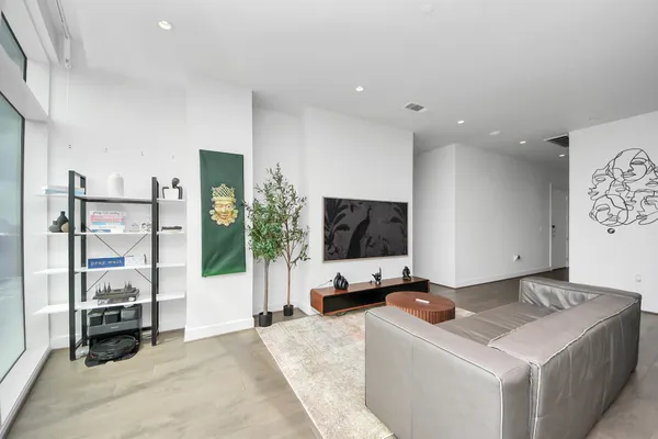 a living room with a flat screen tv and view of living room