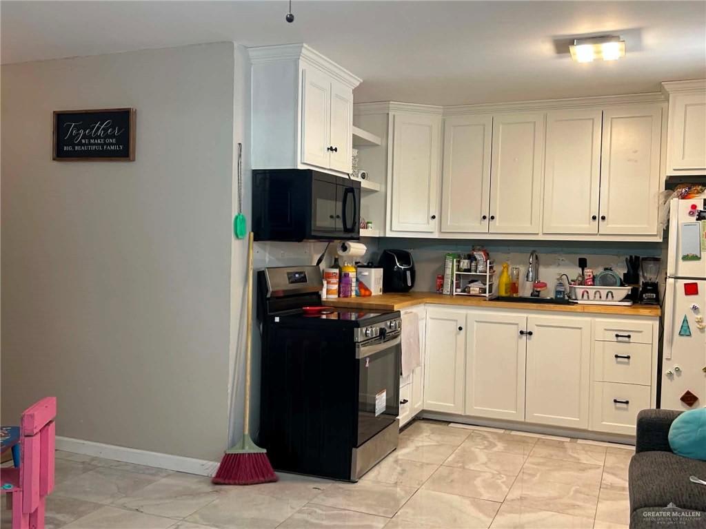 1104 Esperanza Road Alamo, TX 78516 - Photo 6 of 21 a kitchen with stainless steel appliances granite countertop a refrigerator stove top oven and sink