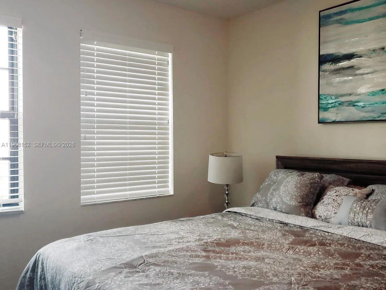 412 Northwest 72nd Street Boca Raton, FL 33487 - Photo 13 of 13 a bedroom with a bed and a window