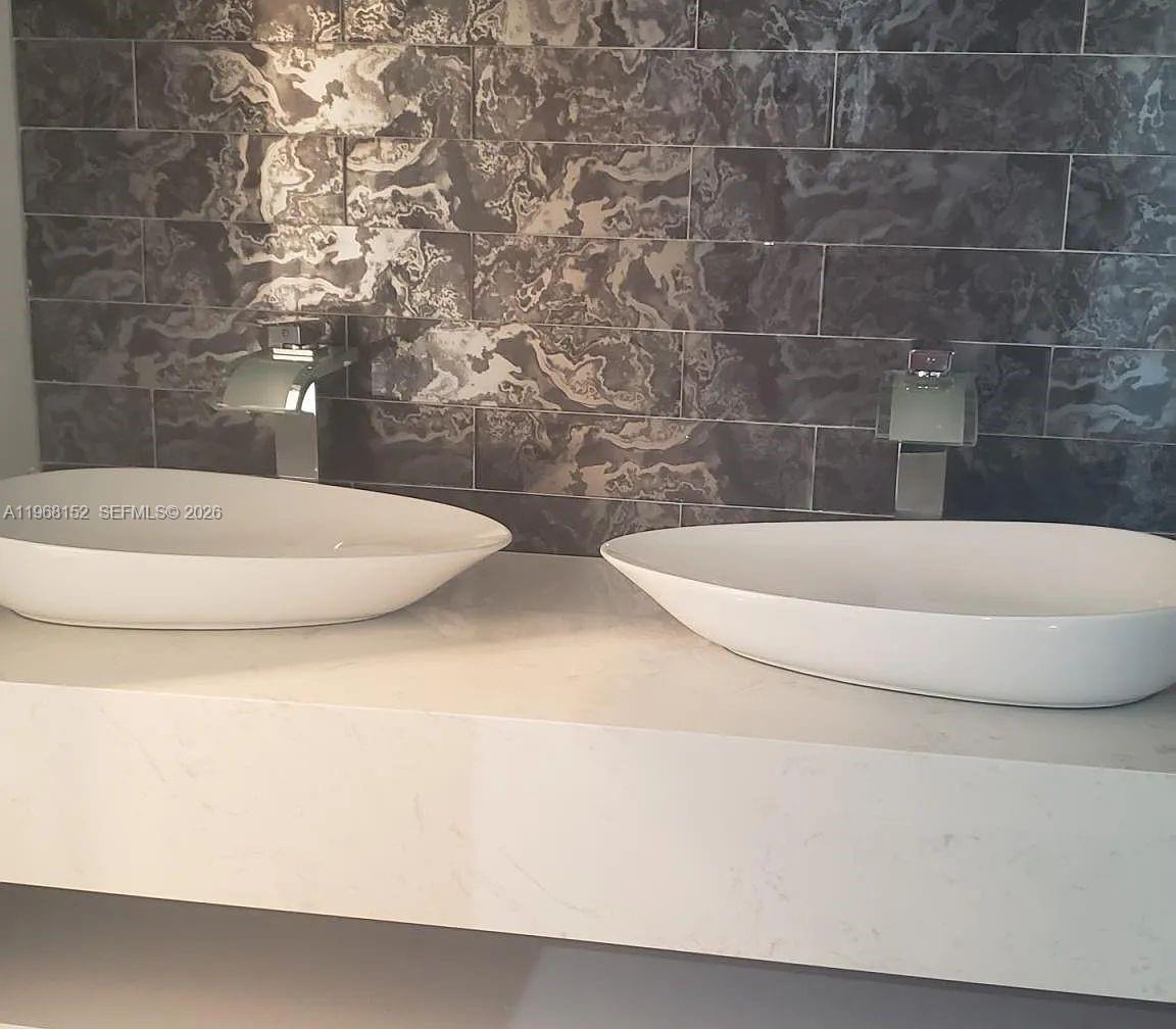 412 Northwest 72nd Street Boca Raton, FL 33487 - Photo 7 of 13 a white bath tub sitting in a bathroom