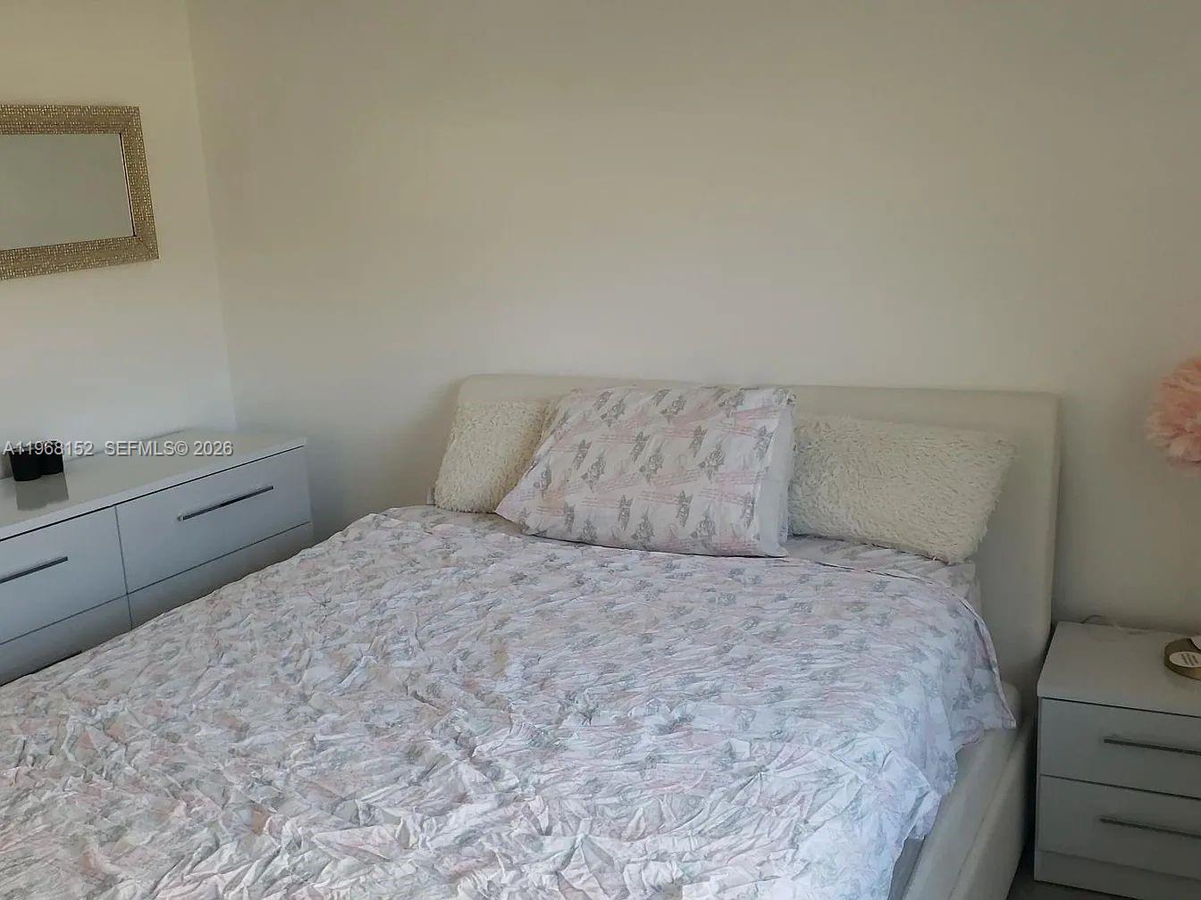 412 Northwest 72nd Street Boca Raton, FL 33487 - Photo 9 of 13 a bedroom with a bed and a window