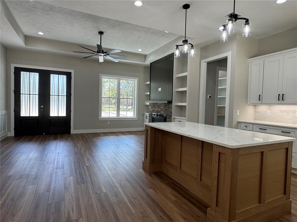 5151 Northwest 73rd Street Chiefland, FL 32626 - Photo 12 of 58 a kitchen with wooden floors and a view of living room