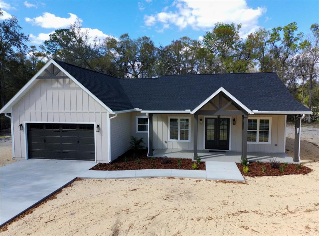 5151 Northwest 73rd Street Chiefland, FL 32626 - Photo 2 of 58 a front view of a house with a yard covered in snow