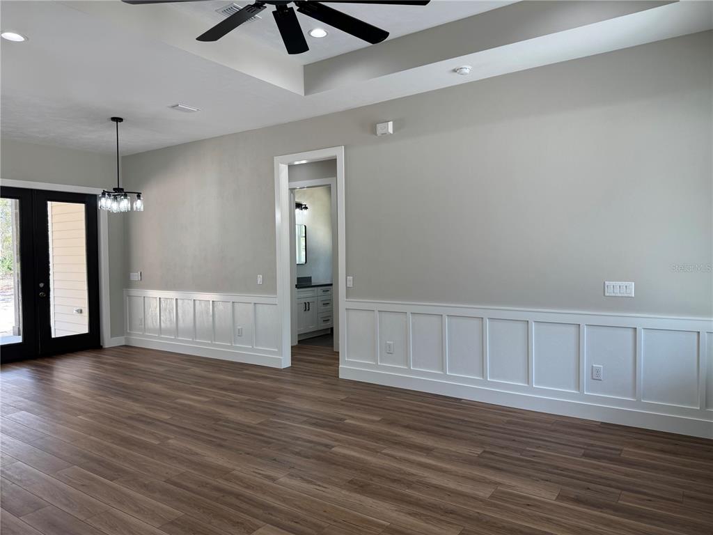 5151 Northwest 73rd Street Chiefland, FL 32626 - Photo 21 of 58 a view of an empty room with wooden floor