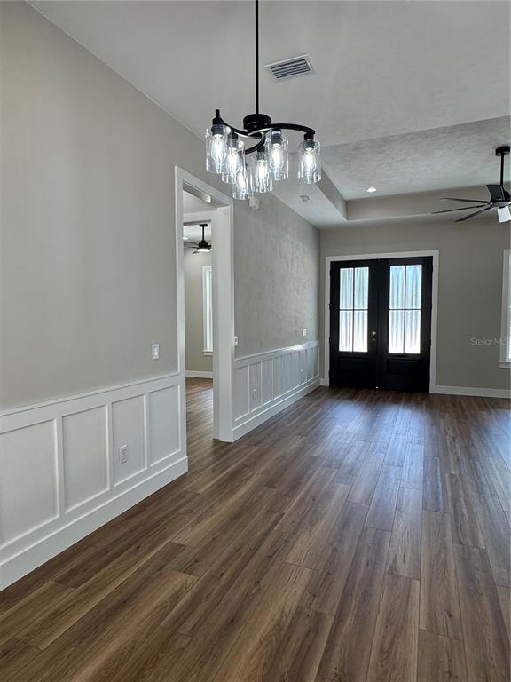 5151 Northwest 73rd Street Chiefland, FL 32626 - Photo 23 of 58 a view of an empty room with wooden floor and kitchen view