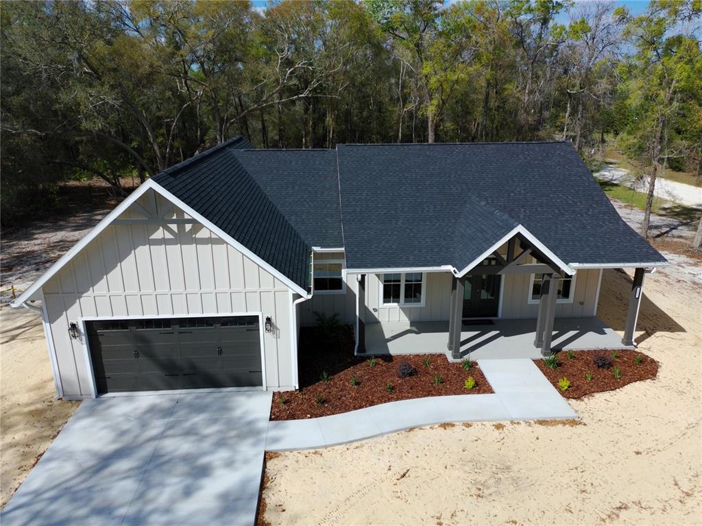 5151 Northwest 73rd Street Chiefland, FL 32626 - Photo 3 of 58 a front view of house with yard and trees in the background