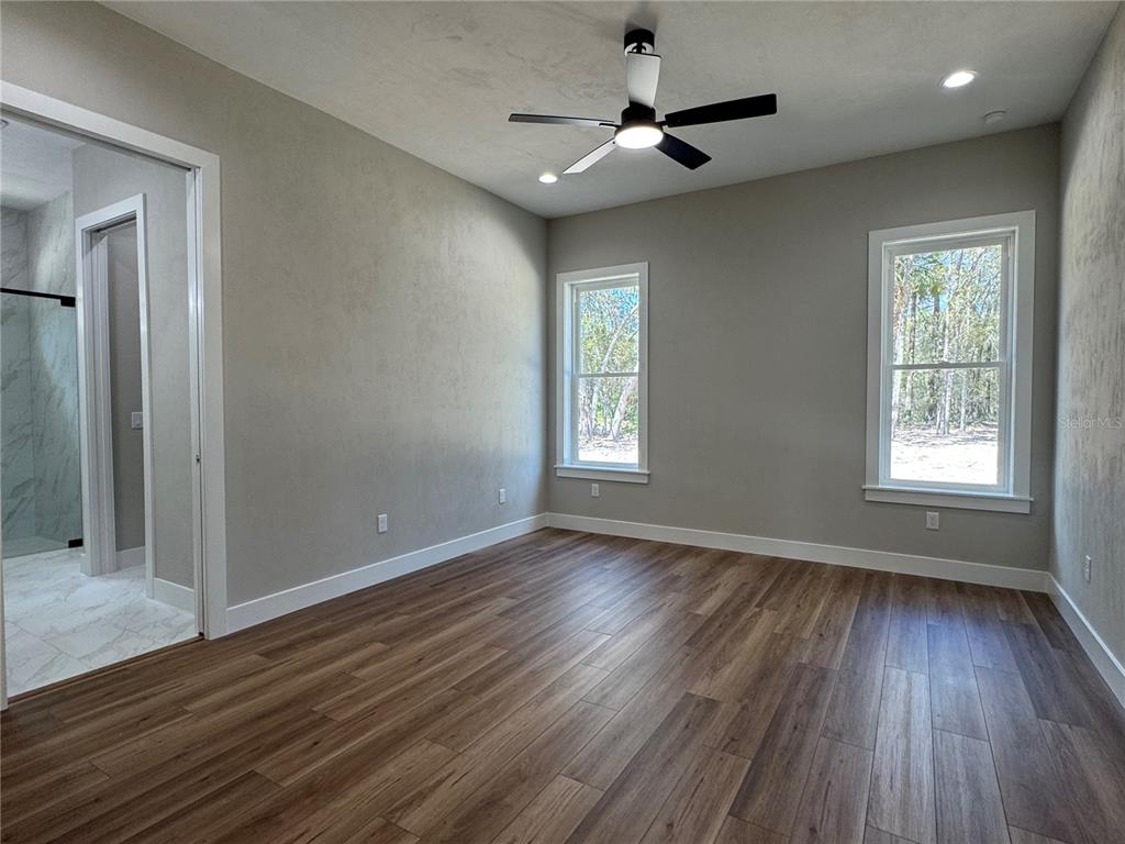 5151 Northwest 73rd Street Chiefland, FL 32626 - Photo 39 of 58 a view of an empty room with wooden floor and a window