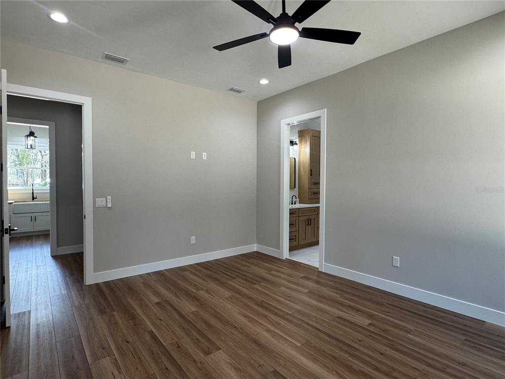 5151 Northwest 73rd Street Chiefland, FL 32626 - Photo 40 of 58 wooden floor in an empty room with a window