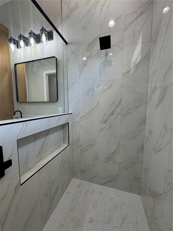 5151 Northwest 73rd Street Chiefland, FL 32626 - Photo 45 of 58 a bathroom with a mirror and a shower
