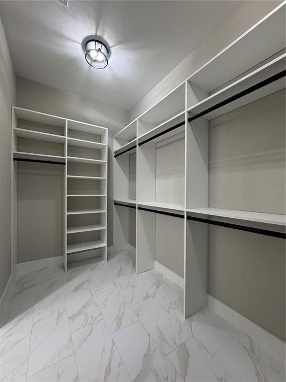 5151 Northwest 73rd Street Chiefland, FL 32626 - Photo 47 of 58 a view of walk in closet with empty racks