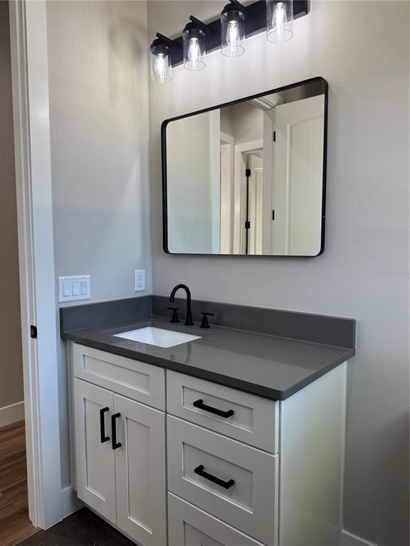 5151 Northwest 73rd Street Chiefland, FL 32626 - Photo 51 of 58 a bathroom with a granite countertop sink and a mirror