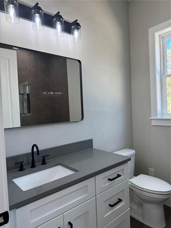 5151 Northwest 73rd Street Chiefland, FL 32626 - Photo 54 of 58 a bathroom with a toilet sink and mirror