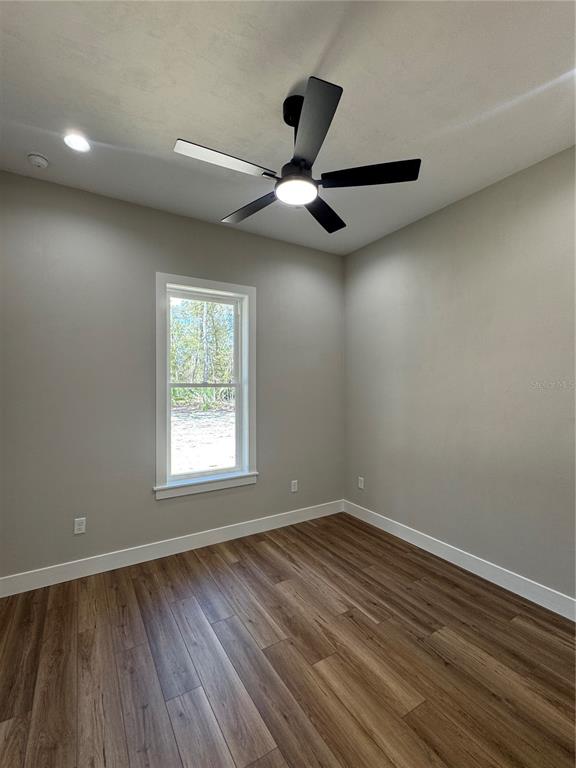 5151 Northwest 73rd Street Chiefland, FL 32626 - Photo 55 of 58 a view of empty room with wooden floor and fan
