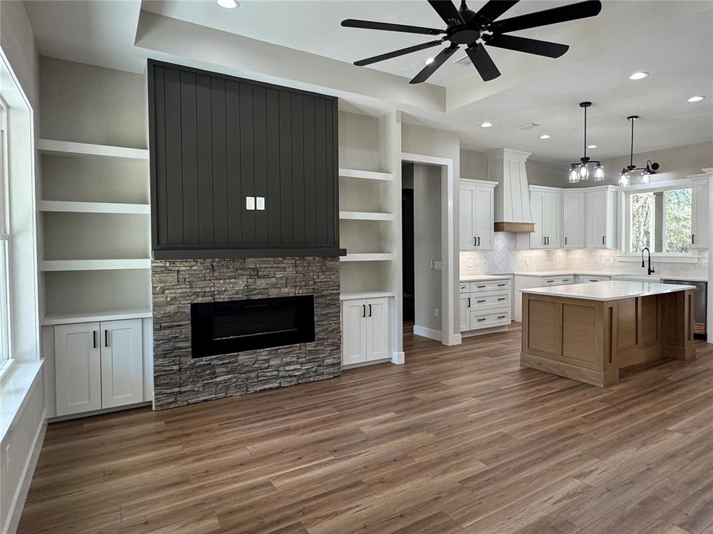 5151 Northwest 73rd Street Chiefland, FL 32626 - Photo 8 of 58 a living room with stainless steel appliances kitchen island a fireplace and wooden floor
