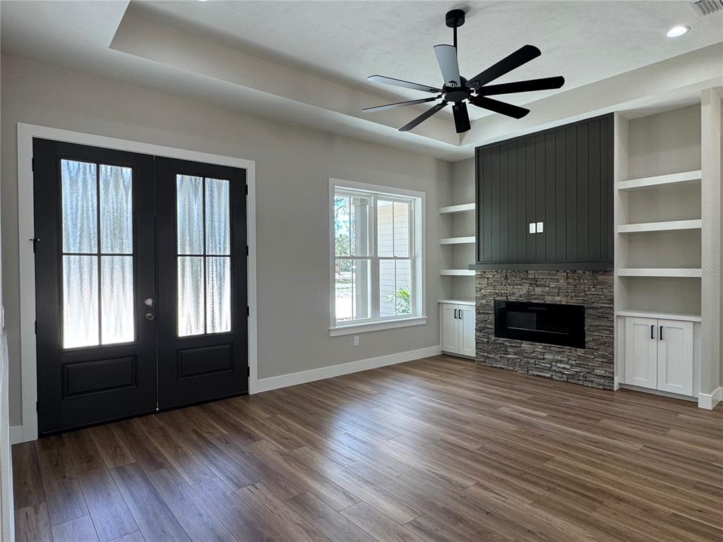 5151 Northwest 73rd Street Chiefland, FL 32626 - Photo 10 of 58 a view of a livingroom with a fireplace wooden floor and window