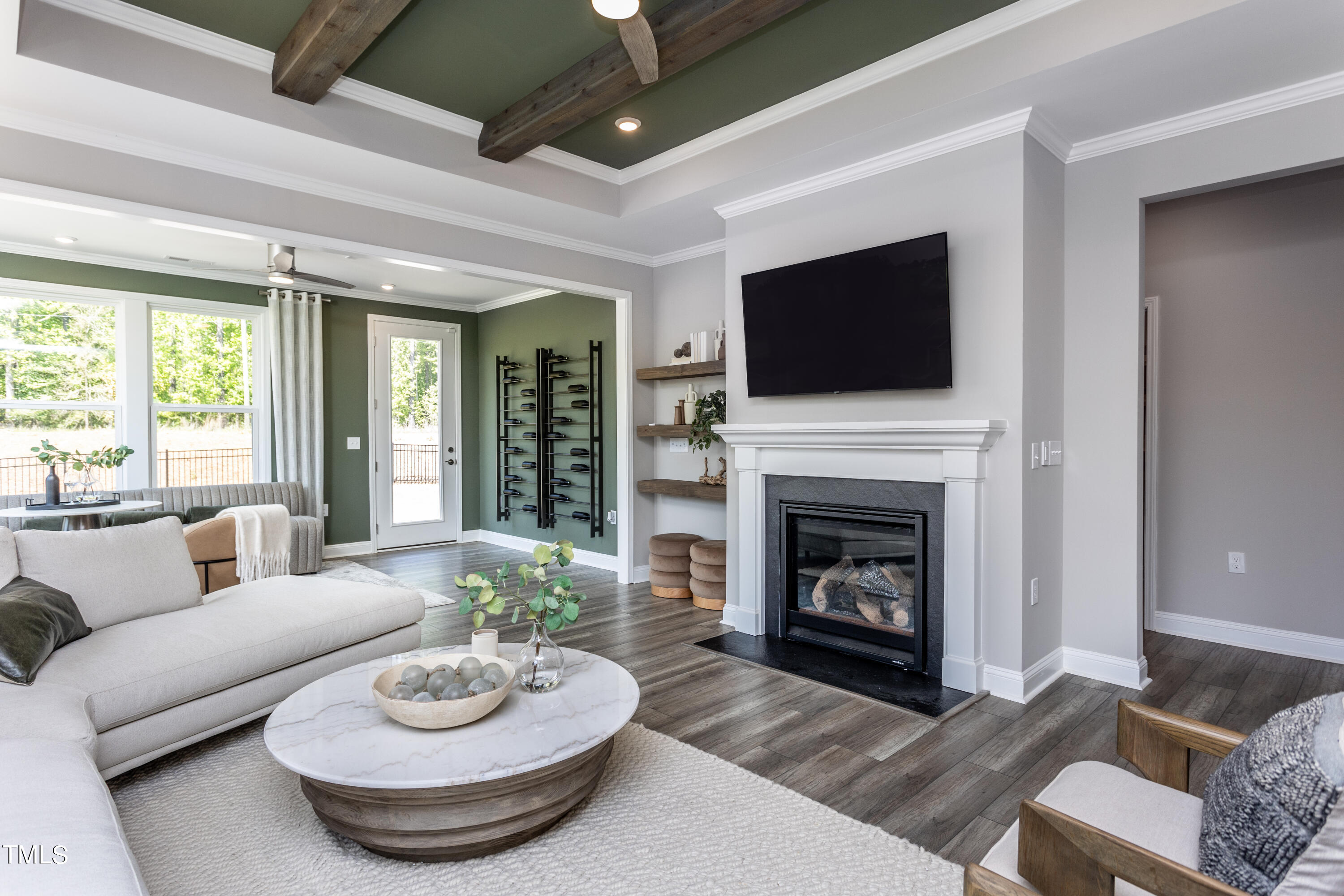 71 Secretariat Drive Clayton, NC 27520 - Photo 11 of 24 a living room with furniture a fireplace and a flat screen tv