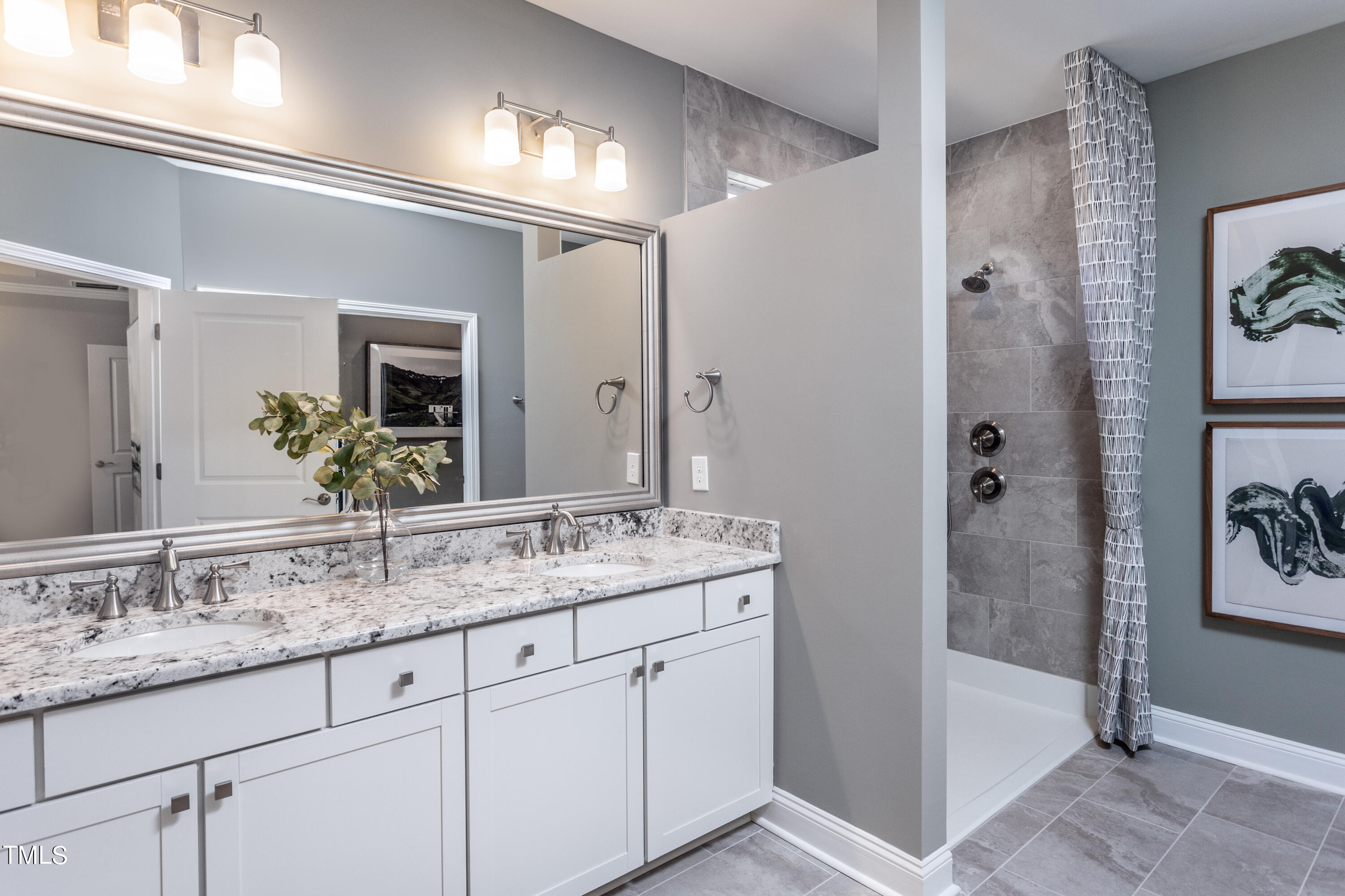 71 Secretariat Drive Clayton, NC 27520 - Photo 17 of 24 a bathroom with a granite countertop sink and a mirror