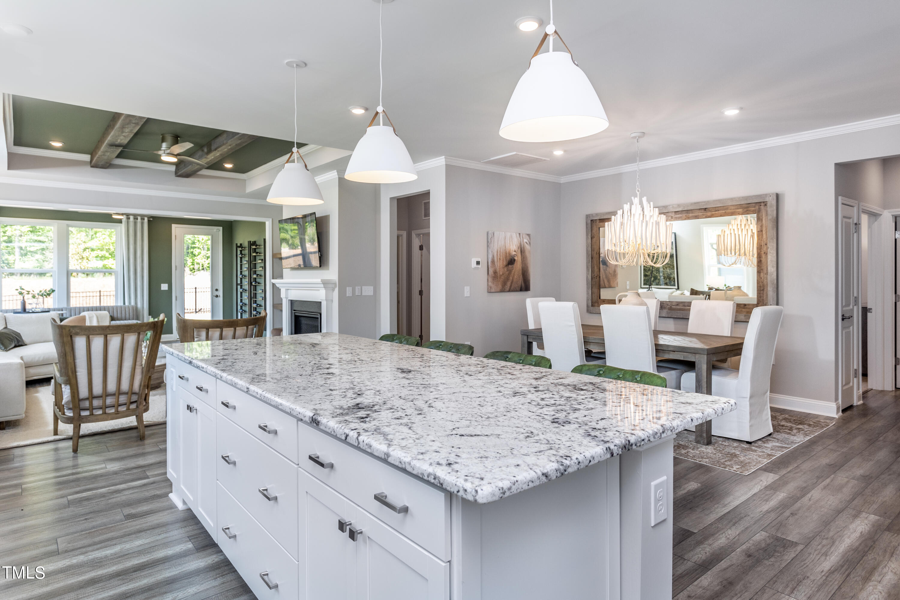 71 Secretariat Drive Clayton, NC 27520 - Photo 8 of 24 a view of living room kitchen with granite countertop wooden floor and stainless steel appliances
