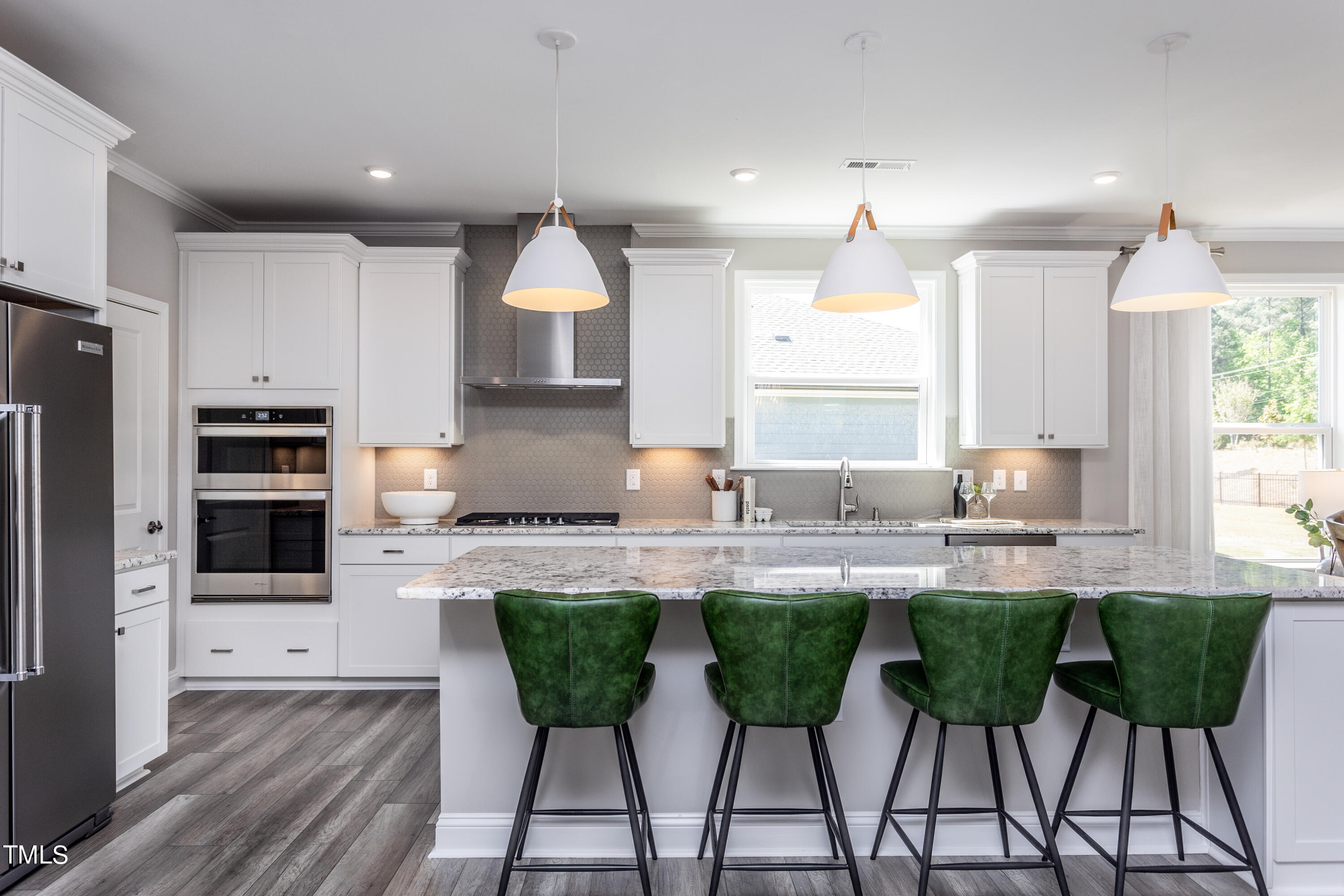 71 Secretariat Drive Clayton, NC 27520 - Photo 9 of 24 a kitchen with kitchen island granite countertop a sink and white cabinets