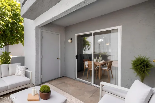 a living room with furniture and a potted plant