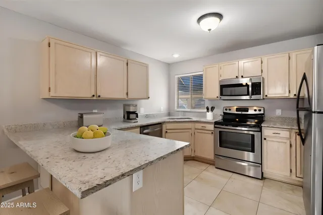 a kitchen with a sink a stove and cabinets
