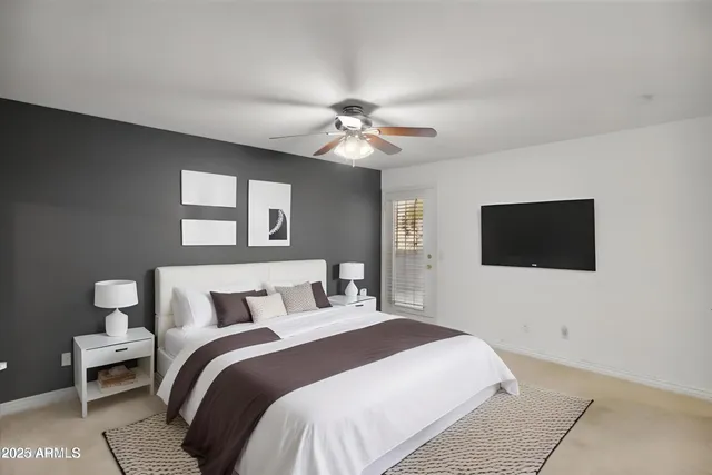 a bedroom with a bed and a flat screen tv