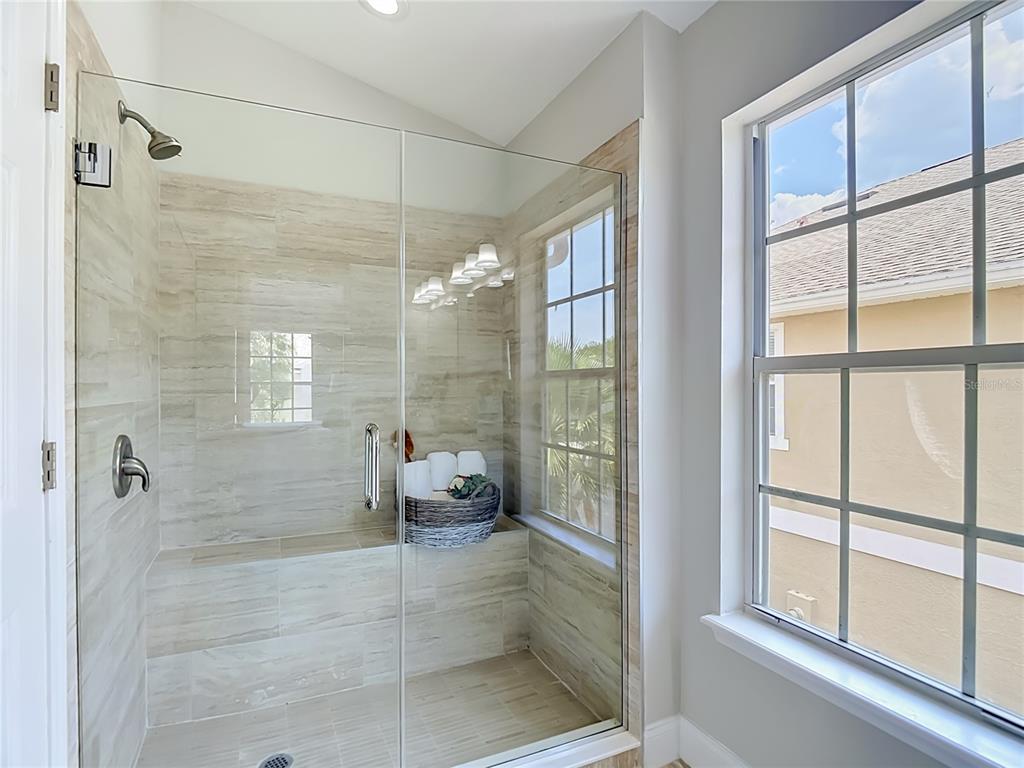 5310 Anhinga Trail New Port Richey, FL 34653 - Photo 18 of 27 a bathroom with a glass shower door