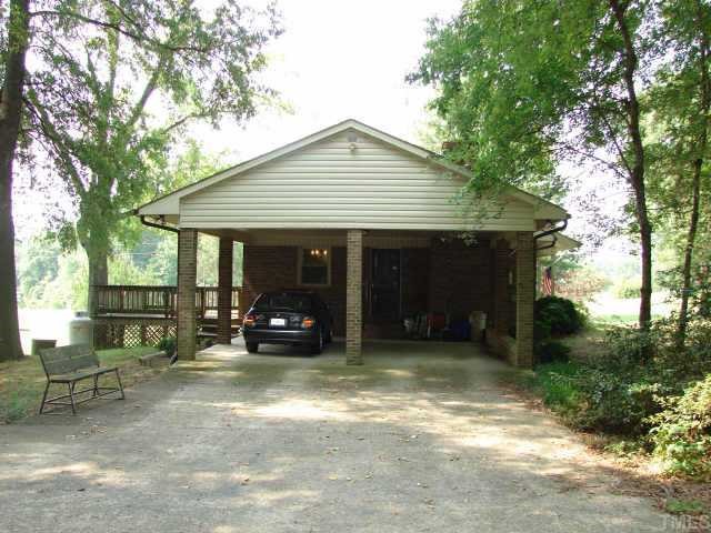 4812 Bahama Road Rougemont, NC 27572 - Photo 6 of 8 a view of a house that has a small yard and large tree