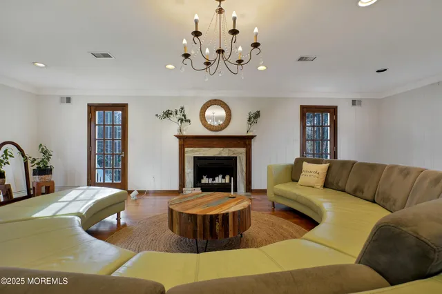 a living room with furniture and a chandelier