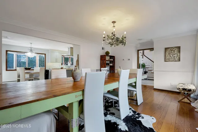 a dining room with furniture a window and a chandelier